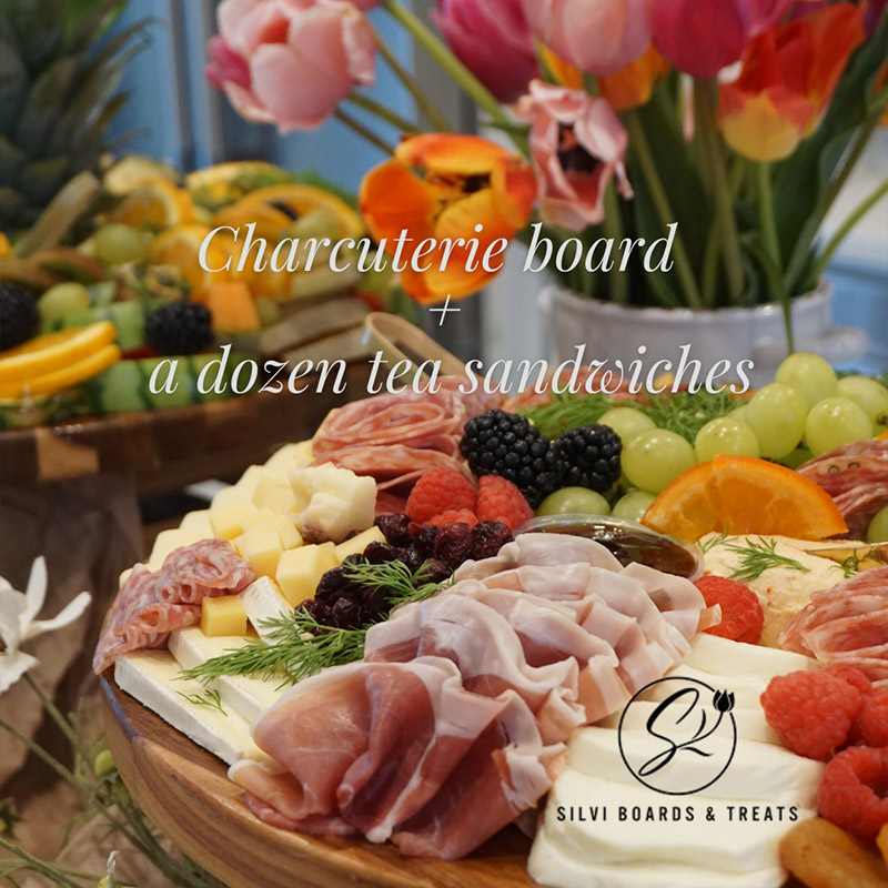 medium charcuterie board paired with a dozen tea sandwiches